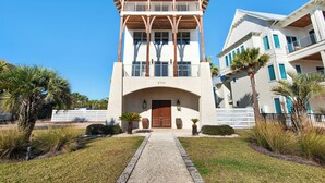 A two-story building with a central entrance, a covered upper balcony, and a number "5702" on the facade. - SNOW BIRDS ONLY.  LOOKING FOR A 3 MONTH RENTAL.  Delightful Santa Rosa Beach (Santa Rosa Beach)
