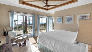 A bedroom with a large bed, a ceiling fan, and a view of the outdoors through large windows. - SNOW BIRDS ONLY.  LOOKING FOR A 3 MONTH RENTAL.  Delightful Santa Rosa Beach (Santa Rosa Beach)