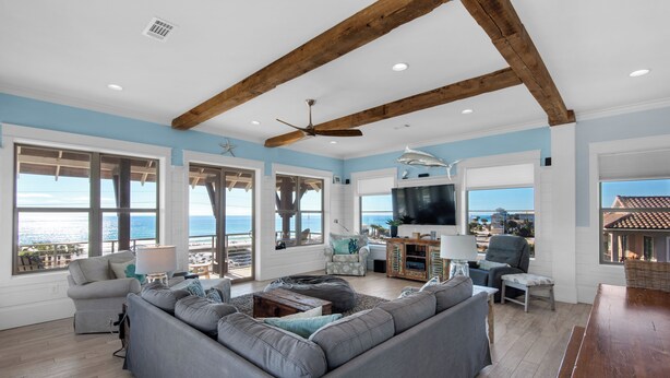 A spacious living room with a large gray sectional sofa, a wooden ceiling, and a large TV. - SNOW BIRDS ONLY.  LOOKING FOR A 3 MONTH RENTAL.  Delightful Santa Rosa Beach (Santa Rosa Beach)