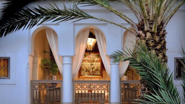 A building facade with three arched windows, each with a decorative railing and a hanging lamp. - Sublime suite in a magnificent Riad with Pool (Marrakesh)