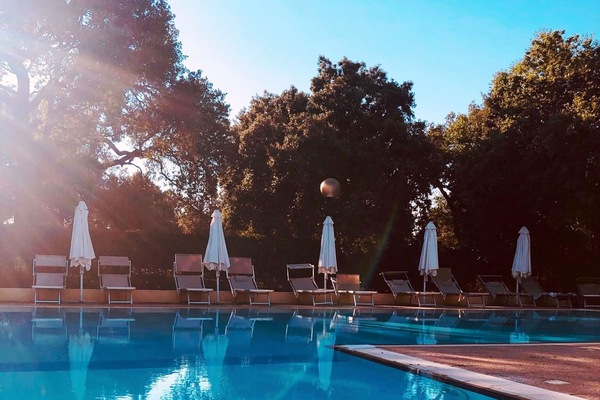 Seasonal outdoor pool, open 9:30 AM to 7:00 PM, pool umbrellas