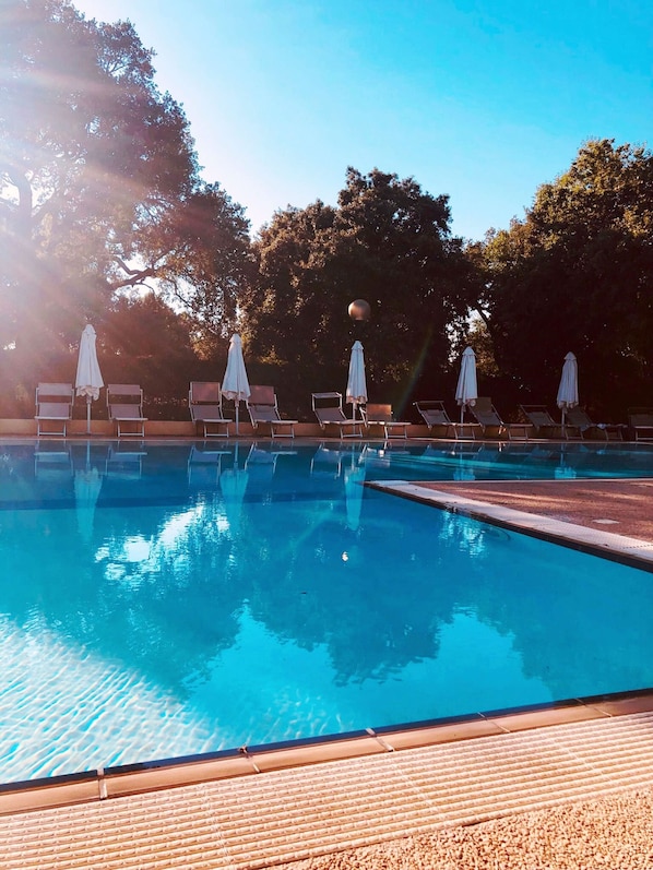 Seasonal outdoor pool, open 9:30 AM to 7:00 PM, pool umbrellas