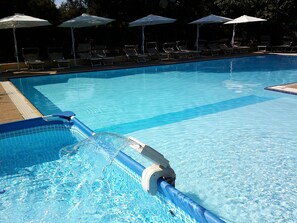 Seasonal outdoor pool, open 9:30 AM to 7:00 PM, pool umbrellas