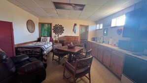 Una sala acogedora con cama, una mesa de comedor y una zona de cocina.