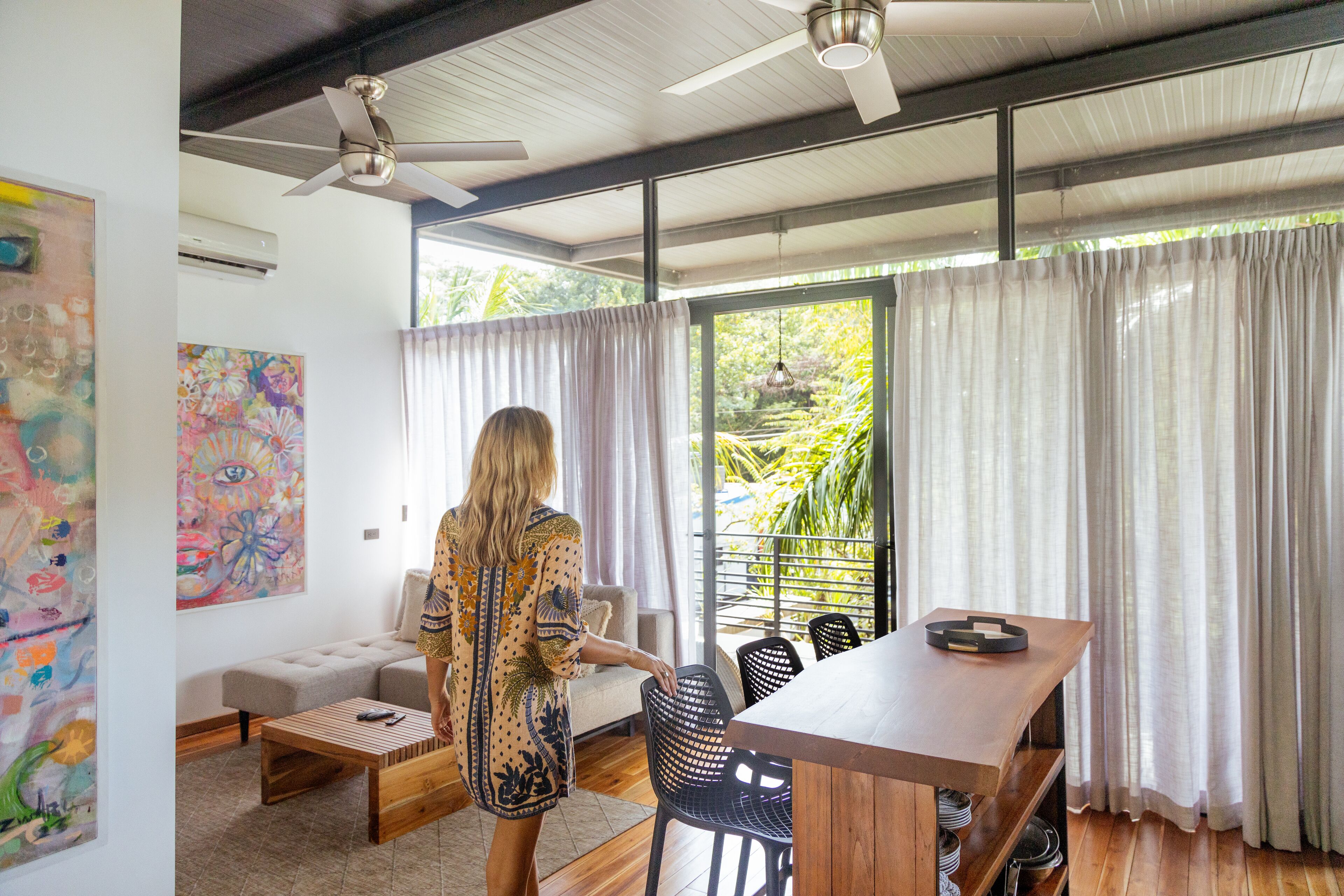 A spacious living area with a sofa, coffee table, and dining table.