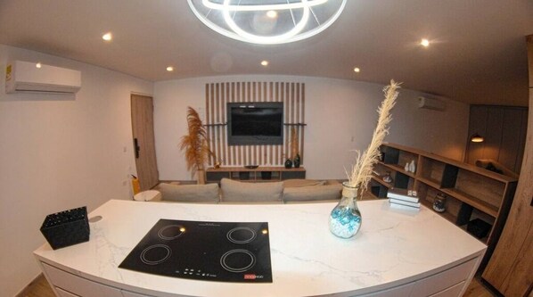 Enjoy cooking in the kitchen with an induction cooktop and ample countertop space.