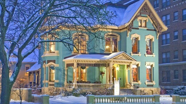 A large, historic building with a prominent porch and multiple windows. - Experience a relaxing, cozy and friendly stay. Walking distance to downtown! (KALAMAZOO)