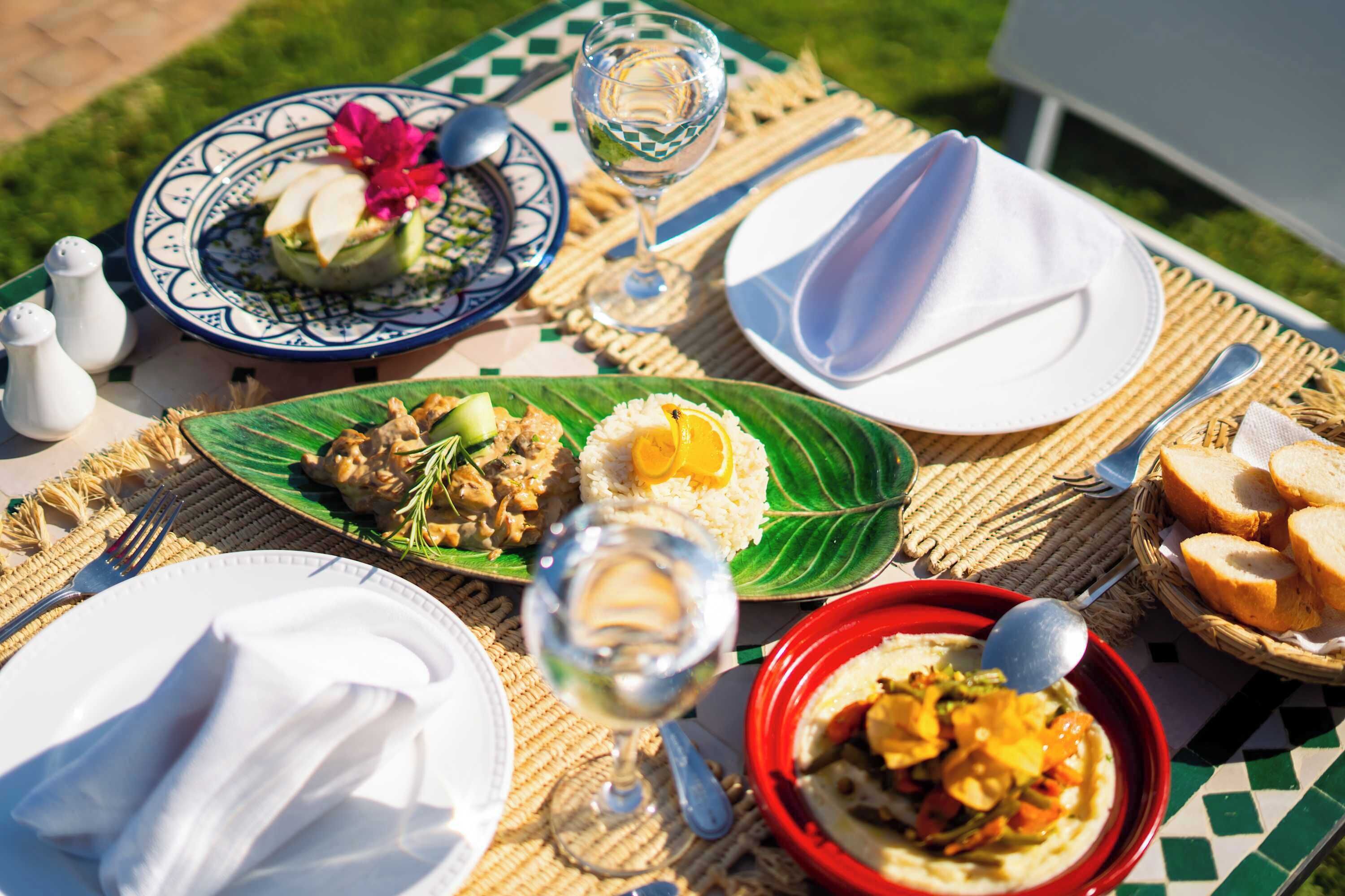 A table set with plates, bowls, and glasses, likely for a meal.