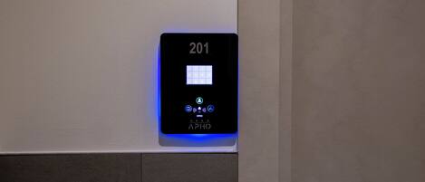 A digital keypad with the number 201 on a wall, indicating a room number.