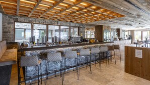 A modern bar area with stone walls, wooden ceiling beams, and bar stools. - Pleasant Apartment Near Ehrwald Town (Ehrwald)