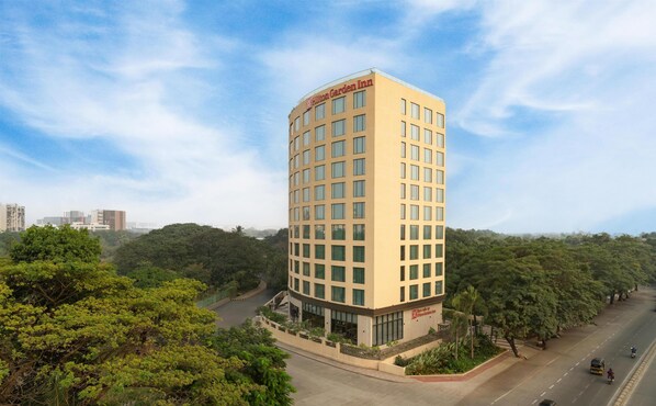 A tall, modern hotel with a flat roof and a prominent sign at the top. - Hilton Garden Inn Mumbai International Airport (Mumbai)