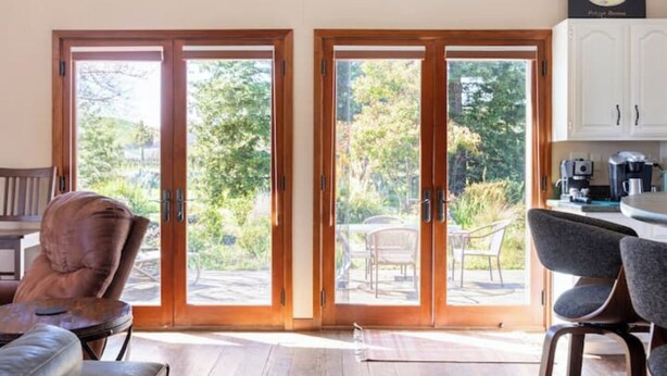 A room with a wooden door leading to a patio with outdoor seating. - Beaufiul Sonoma house on large property in vineyards with lots of amenities! (Sonoma)