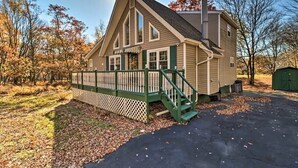 A two-story house with a front porch and a covered front entrance.