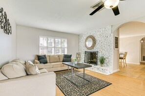 Relax in this inviting living space with a sofa, coffee table, and fireplace.