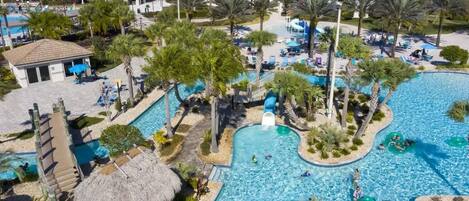 A resort with multiple swimming pools, palm trees, and lounge areas.