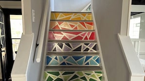 Portaat, joiden askelmissa on värikkäitä, geometrisiä kuvioita.