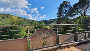 A bridge with a metal railing and a decorative tree design on the side. - L'Echappée du Camboux.  
Wellness discounts (Sainte-Cécile-d'Andorge)