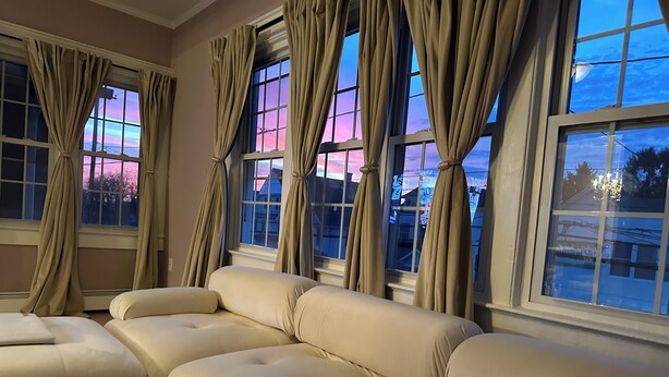A room with a beige sofa set and large windows with curtains. - Private Cozy 2-bedroom apartment in charming Scranton with AC (Scranton)