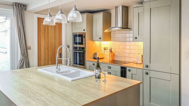 A modern kitchen with a central island, stainless steel appliances, and pendant lighting. - 2 bedroom accommodation in Beverley (Beverley)