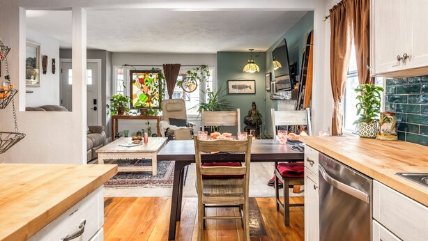 Une cuisine et un coin repas accueillants, avec des meubles en bois, une table à manger, des chaises et un comptoir de cuisine.