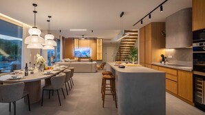 A modern kitchen with a central island, wooden cabinets, and pendant lighting. - Villa ZaLú with Heated Pool (Srinjine)