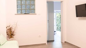A room with a bed, a window, and a door leading to an outdoor area. - Izola Spacious Apartment with Terrace and Patio - Three Bedroom Apartment with Terrace (Izola)
