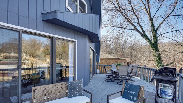 A deck with outdoor furniture, a barbecue grill, and a large window overlooking a backyard. - Lakefront Home w/ Dock & Decks in Gravois Mills! (Gravois Mills)