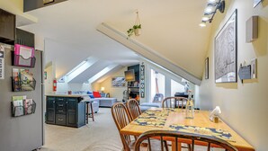 A spacious kitchen with a dining area, a built-in fridge, and a loft bedroom with a view. - Walk to Mount Snow Resort: Unit w/ Pool & Hot Tubs (Dover)