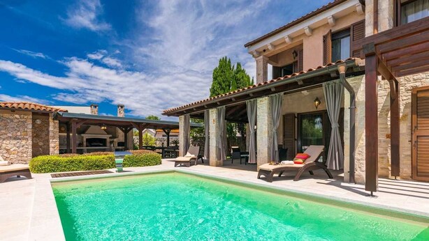 A pool area with lounge chairs and a pergola. - Villa Forte with Heated Private Pool close to the Beach (Porat (Krk))