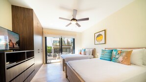 A hotel room with a bed, a TV, a ceiling fan, and a balcony with a view. - Modern PH with 2 Br & Pool at Arena 509 (Playa del Carmen)