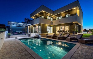 A modern two-story house with a swimming pool and outdoor seating area. - Villa Evoque | Adriatic Luxury Villas (Crno)