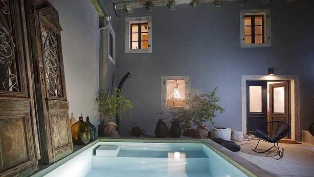 A serene indoor pool area with a clear pool, wooden cabinets, and potted plants. - Artistic Villa B1 - Adriatic Luxury Villas (Radetići)