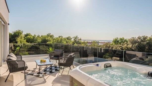 A rooftop terrace with a hot tub, seating area, and a clear view of the sea. - Villa Pollux | Adriatic Luxury Villas (Vrsi)
