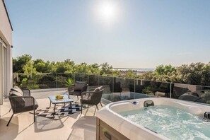 A rooftop terrace with a hot tub, seating area, and a clear view of the sea. - Villa Pollux | Adriatic Luxury Villas (Vrsi)