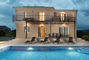A two-story house with a swimming pool, outdoor seating, and a balcony. - Villa Oliva | Adriatic Luxury Villas (Murvica)