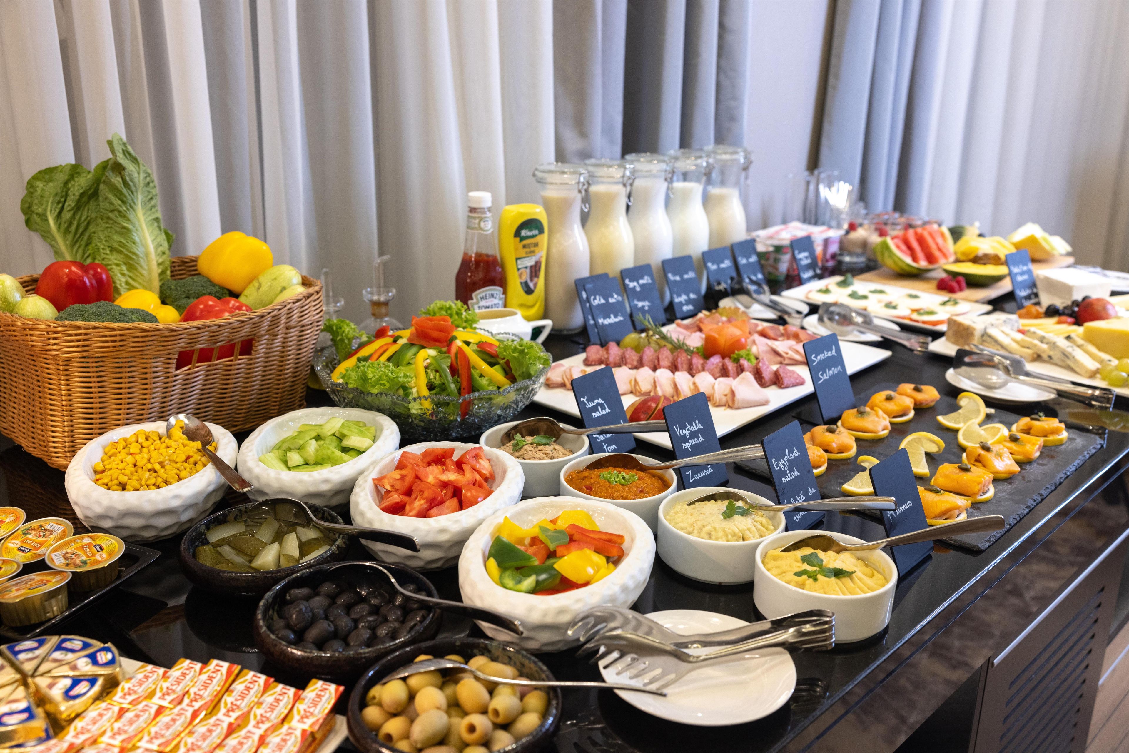 A buffet with various food items and condiments.