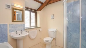 A bathroom with a sink, toilet, and bathtub.