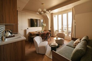 Enjoy a spacious living area with a dining table, sofa, and armchairs.