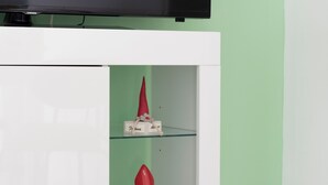 A white entertainment unit with a flat-screen TV mounted above it.