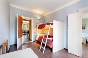 A room with a bunk bed, a ladder, a door, and a hallway leading to another room. - ‘Cabianchi Royal Suite’ Apartment with Lake View, Balcony and Wi-Fi (Orta San Giulio)