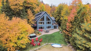 A large two-story house with a prominent gable roof and a covered patio area. - Camp David Beautiful five bedrooms  Private beach (Kearney)