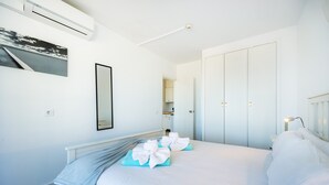 Une chambre d’hôtel équipée d’un lit, d’une armoire, d’un miroir et d’un appareil de climatisation.