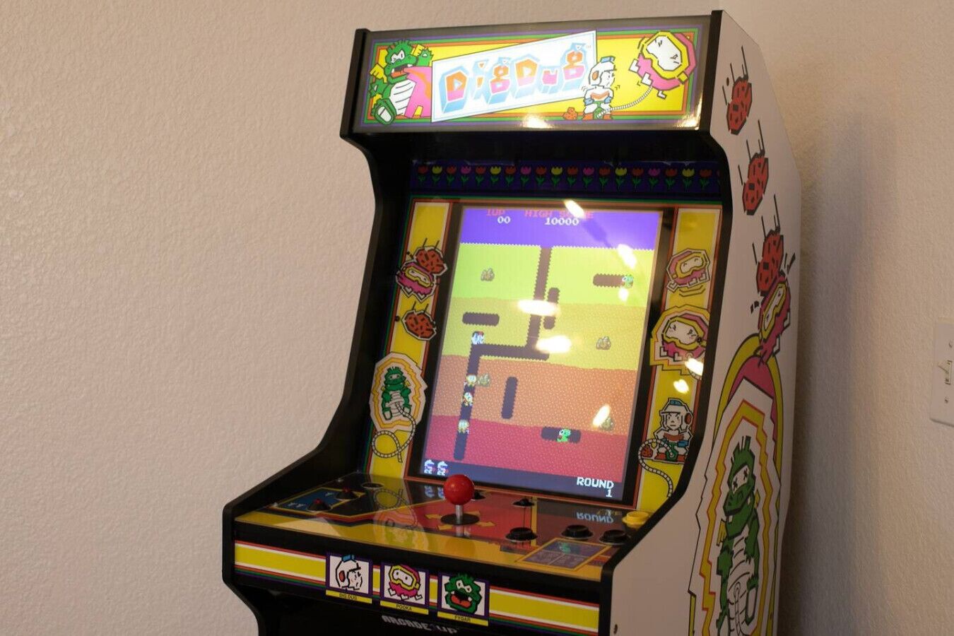 A vintage arcade machine with a colorful display and cartoon characters.