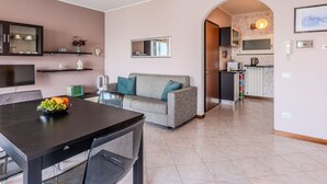 A modern apartment with a dining area, a sofa, a kitchen, and a living room. - Apartment Lella by Interhome (Varenna)
