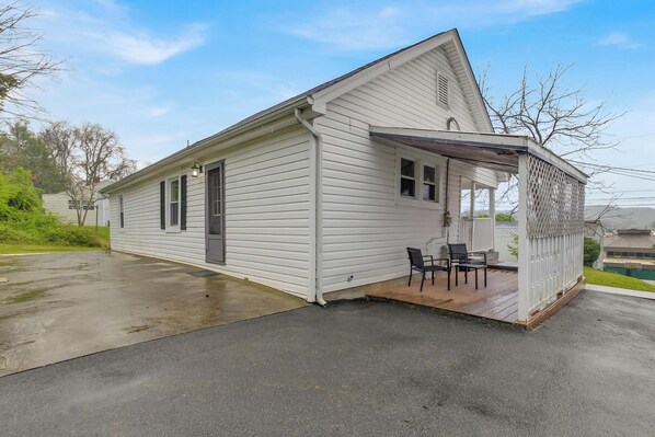 A single-story house with a porch and a small patio area.