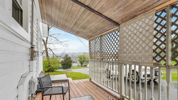 A covered outdoor deck with a wooden ceiling and white railings. - Affordable, Private, Single Level House Steps From Hard Rock Casino Pet Friendly (Bristol)