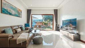 A modern living room with a sofa, coffee table, and TV.