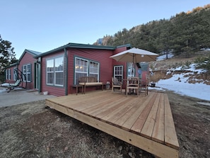 Enjoy a peaceful retreat with a cabin featuring a large window, comfortable seating area, and a deck.