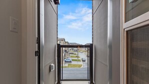 A corridor leading to a street view with a clear sky. - Modern Home With Parking Near Canada's Wonderland! (Vaughan)