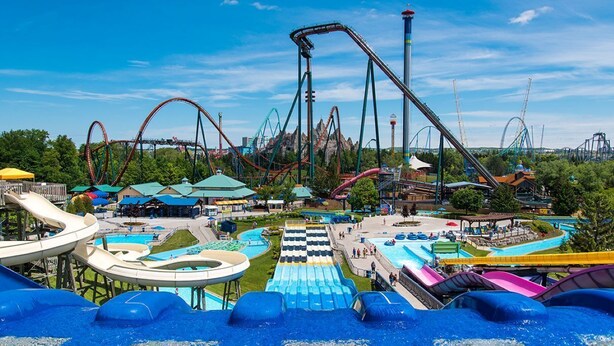 A water park with multiple roller coasters, water slides, and a large pool area. - Modern Home With Parking Near Canada's Wonderland! (Vaughan)